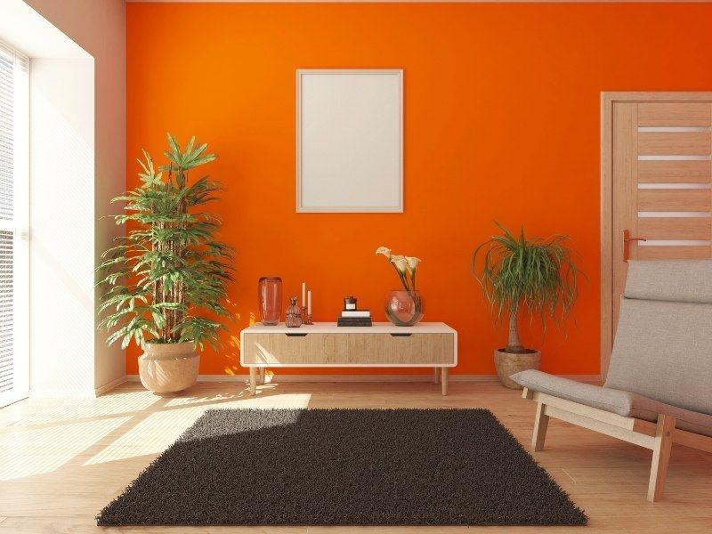 Imagem de uma sala de estar com decoração laranja