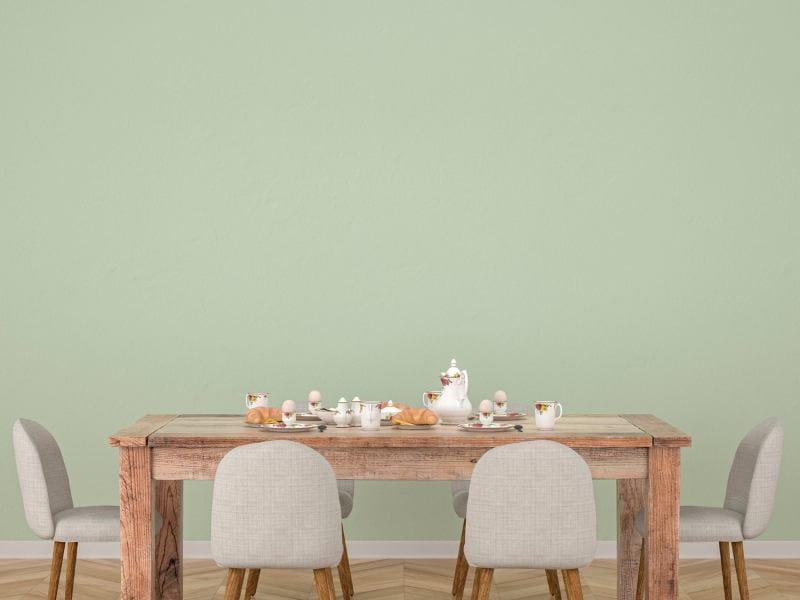 Sala de jantar com parede na cor verde
